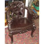 A Chinese ebonised carved open armchair, the splat,