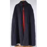 A mid century navy wool nurse's cape, with red neck tie and lining,