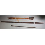 A Masai wooden and iron spear, length 162cm and a quantity of bamboo arrows with metal tips.