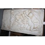 A plaster plaque, depicting five children and a dog, 44.5 x 83cm.