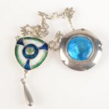 An Arts and Crafts silver enamelled pendant with central stone and plain silver drop on silver