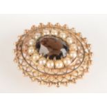 A 9ct gold oval brooch / pendant set a topaz within pearls 10.8g.