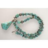 A silver and turquoise middle eastern necklace.