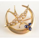 A 15ct gold swallow and crescent brooch set blue stones and pearls.