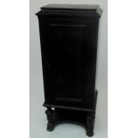 An ebonised 19th century German narrow cabinet, with single panel door, width 54cm, height 133cm.