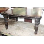 A Victorian carved oak extending dining table, with turned tapering legs and two additional leaves,