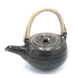 A Brett Guthrie Leach Pottery stoneware teapot, with bamboo handle, personal and pottery seal.