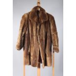 A mid brown lady's fur coat, with burgundy lining, length 86cm, size 10/12.