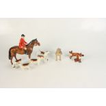 A Beswick hunting group, comprising a huntsman on horseback, five hounds and two foxes.