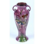 A lemon and crute baluster twin handled butterfly decorated vase, height 30cm.