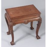A George II style mahogany side table, on shell carved cabriole legs and ball and claw feet,