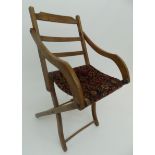 A late Victorian or Edwardian folding deck armchair with carpet seats,