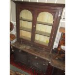 A Victorian pine bookcase, with a pair of glazed doors,
