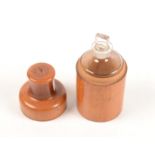 A treen bottle jar and cover, enclosing a glass bottle and stopper,