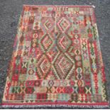 A Chobi kelim rug, with two rows of three polychrome serrated medallions within four borders,