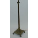 A brass Corinthian column standard lamp, early 20th century, with a square stepped platform base,