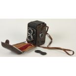 A Prinz camera with a Yashica Copal-MXV lens, in a brown leather case.