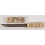 A Japanese carved bone and steel bladed dagger, length 28cm.