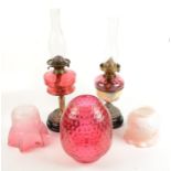 Two late Victorian oil lamps, one with cranberry flash shade,