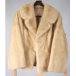 A lady's light beige mink fur coat, with floral patterned gold silk lining, length 65cm, size 8/10.