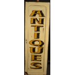 A large painted 'Antiques' sign 57 x 181cm.