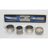 Two Indian silver napkin rings and a pair of Victorian embossed silver open twin handled salts