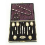 A set of six silver shell bowl Apostle spoons with matching sugar tongs and sugar dredger, cased,