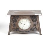 An Arts and Crafts copper cased mantle clock, height 16cm, width 24cm.