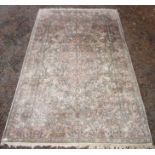 An Indian silk carpet, the ivory field with a large central medallion,