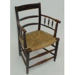 A 19th century William Morris style armchair with woven grass seat,