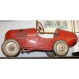 A red painted metal child's pedal car, 1950s/60s, black rubber wheels, height 57cm, length 127cm,