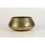 A Cairoware brass bowl, 19th century, with Islamic calligraphy, height 11cm, diameter 23cm.