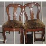 A pair of Victorian mahogany balloon back dining chairs, with cabriole legs.