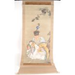 A Chinese painted scroll depicting an immortal, in the company of a deer and child, bone handles,