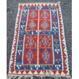 A Turkish kelim, the blue ground with two large square red medallions,