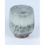 A Bill Marshall stoneware tea bowl, with white glaze breaking to tenmoku, height 10.