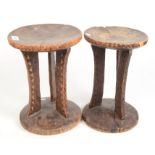 Two African carved wood stools, height 33cm.