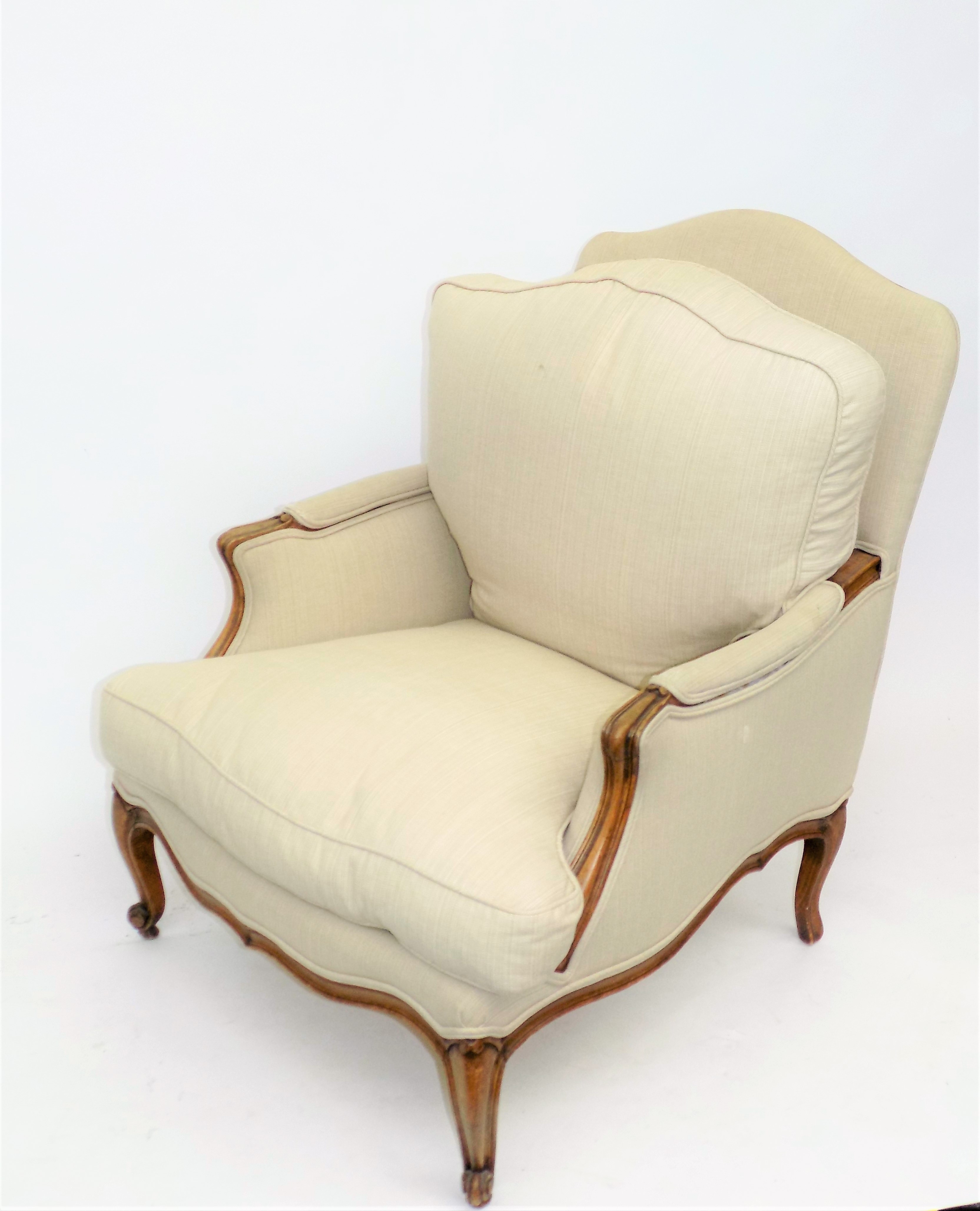 A French walnut upholstered armchair, with carved cabriole legs, height 96cm, width 65cm.