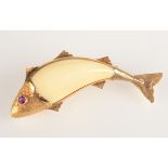 A leaping fish brooch, the body made of a tooth mounted in gold and with a ruby eye.