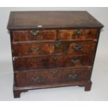 A George II walnut veneered chest of drawers,