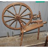 A carved wood spinning wheel, height 103cm.
