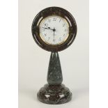 A Cornish serpentine mantel clock, height 32cm, diameter 15cm.