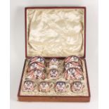 A set of six Royal Crown Derby cups and saucers, in a fitted leather case, height of cups 5cm,