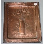 An Arts and Crafts copper wall plaque decorated with a vase of tulips, 51.5 x 44cm.