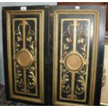 Two black and gilt painted wooden door panels, decorated with scrolling leafy vines, 65.5 x 33cm.
