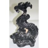 A black painted cast iron doorstop, in the form of a stylised dolphin, height 38.5cm.