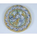 A majolica small plate, the centre decorated with a crossed inscribed banner ad axe, diameter 16cm.