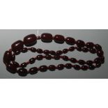 A cherry 'amber' graduated bead necklace, 100g.