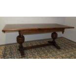 An oak draw leaf dining table, in 16th century style with carved cup and cover supports,