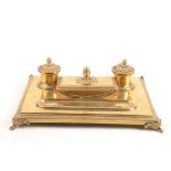 A gilt metal inkstand, circa 1900, with matching blotter, width 33cm, depth 23cm.